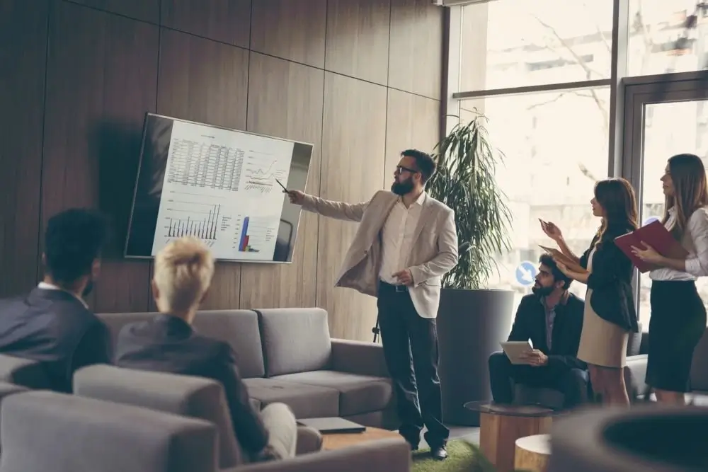 A professional giving a presentation in a modern office.