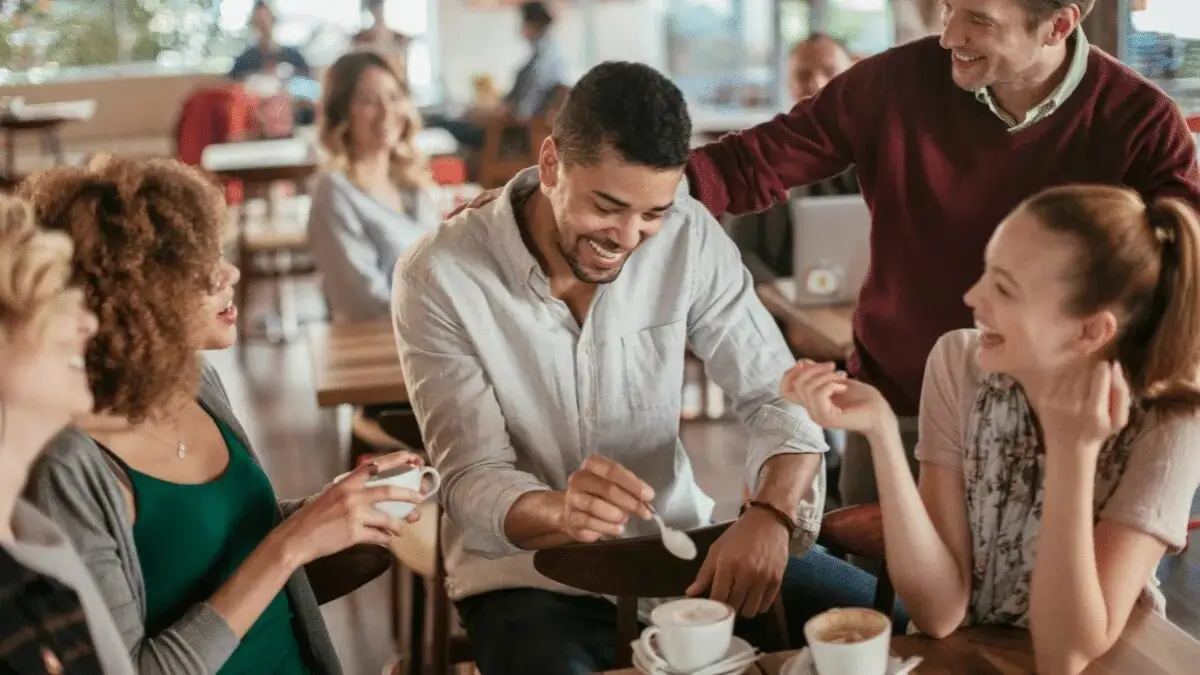 People having a conversation over coffee in a lounge